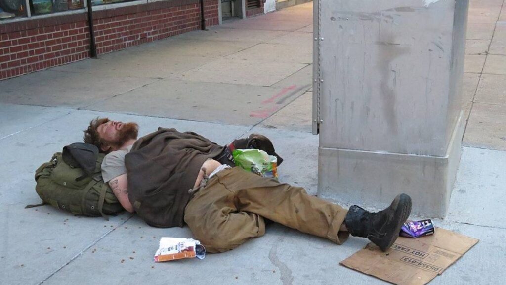 A homeless man sleeping across the street from the Colorado State Capitol.