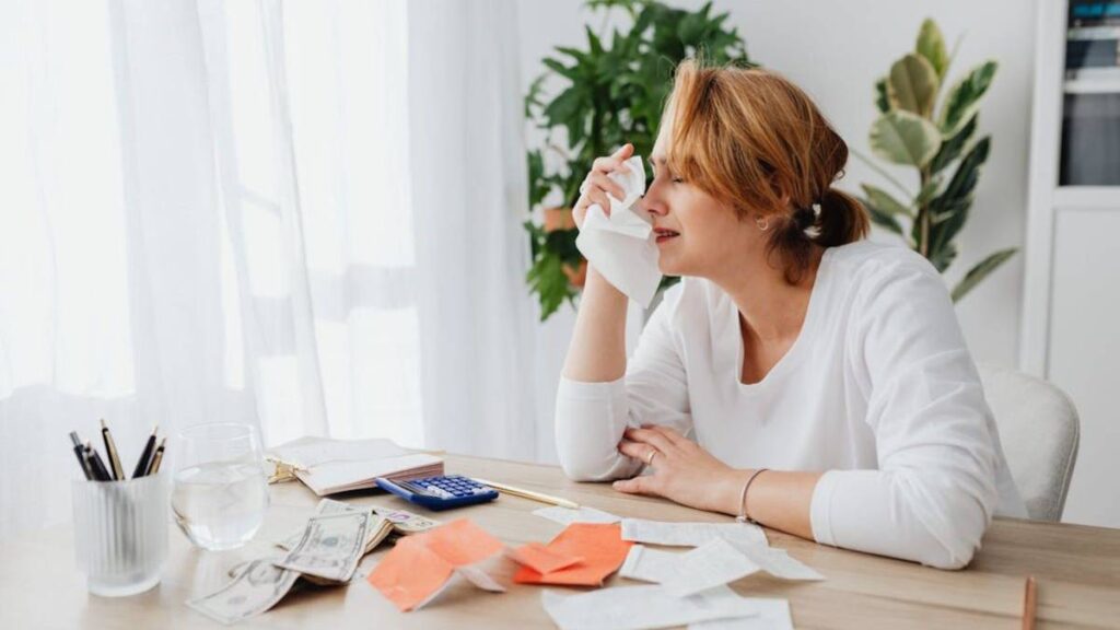 Sad woman crying over her debt