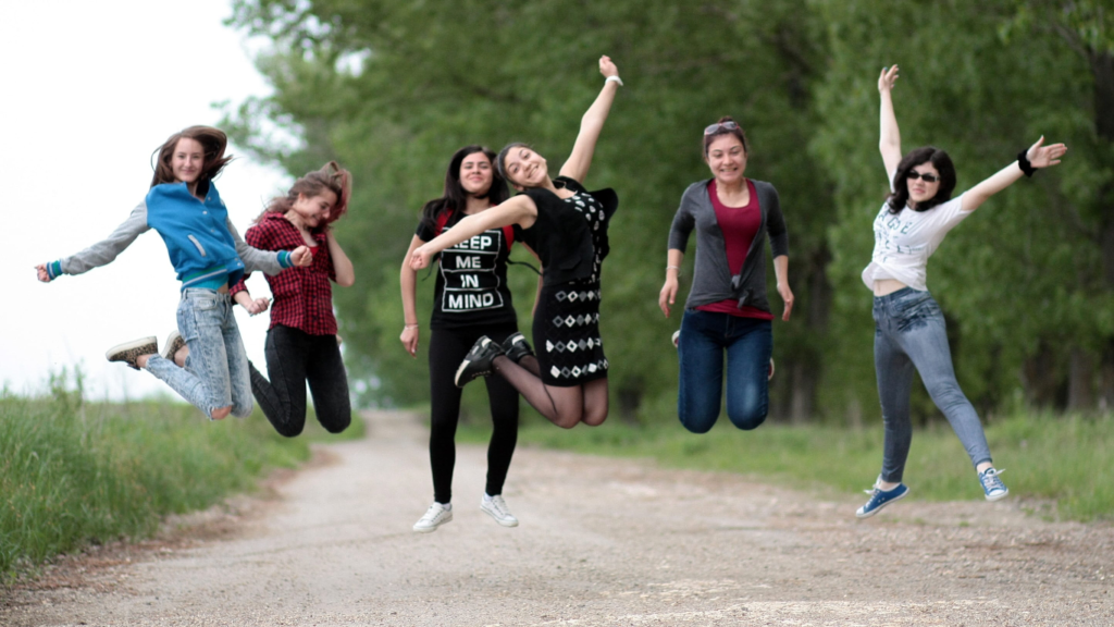 Young women hopping excitedly