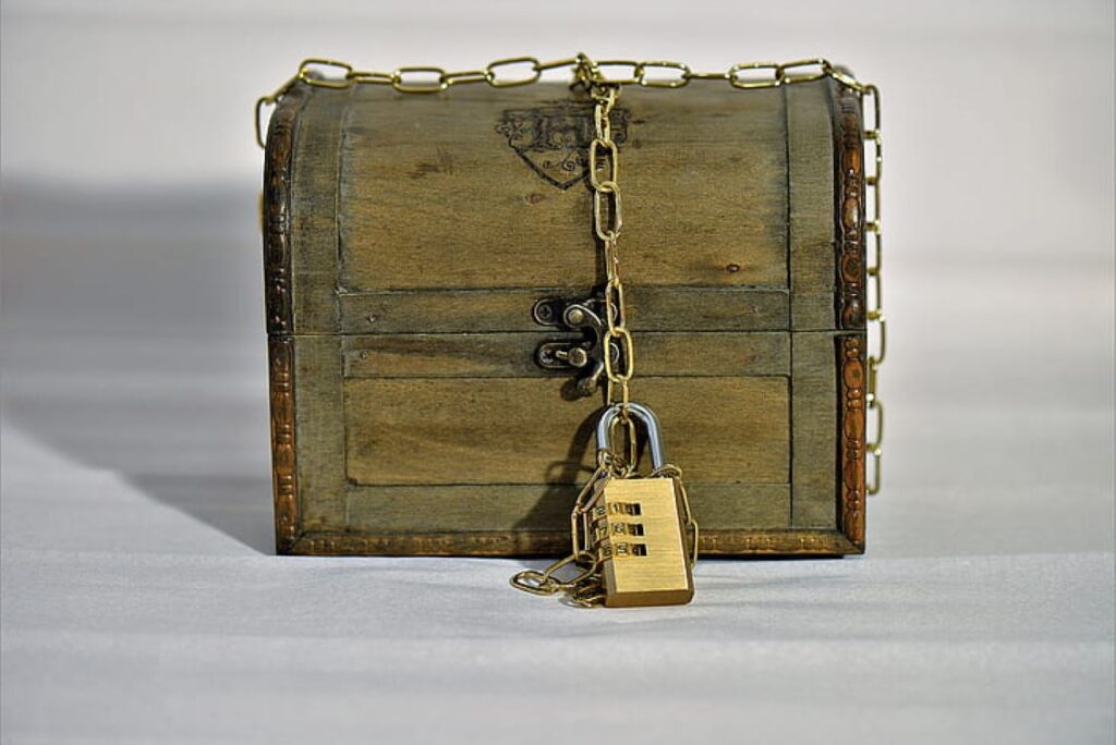 Brown wooden trunk box with brass-colored padlock and chain