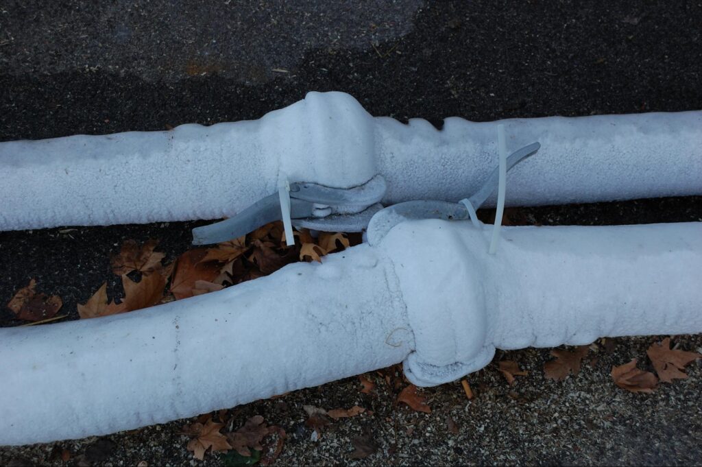 Two pipes frozen over in winter