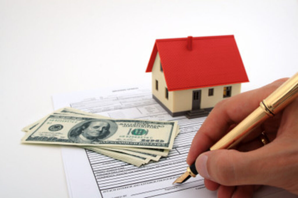 Mortgage documentation, some cash, and a house model