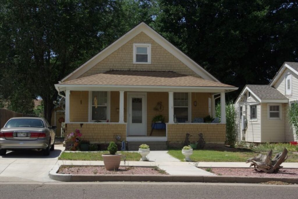 A bungalow with a car in the driveway