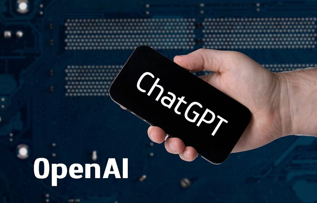 Hand holding smartphone with ChatGPT and OpenAI text