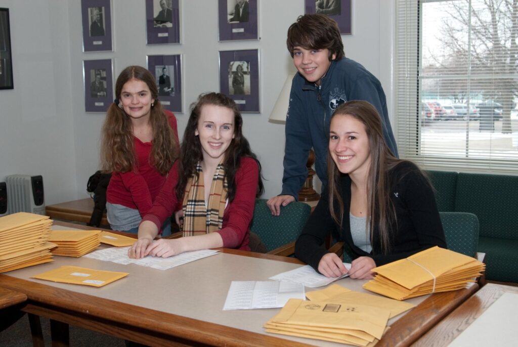 Four student volunteers sealing care packs