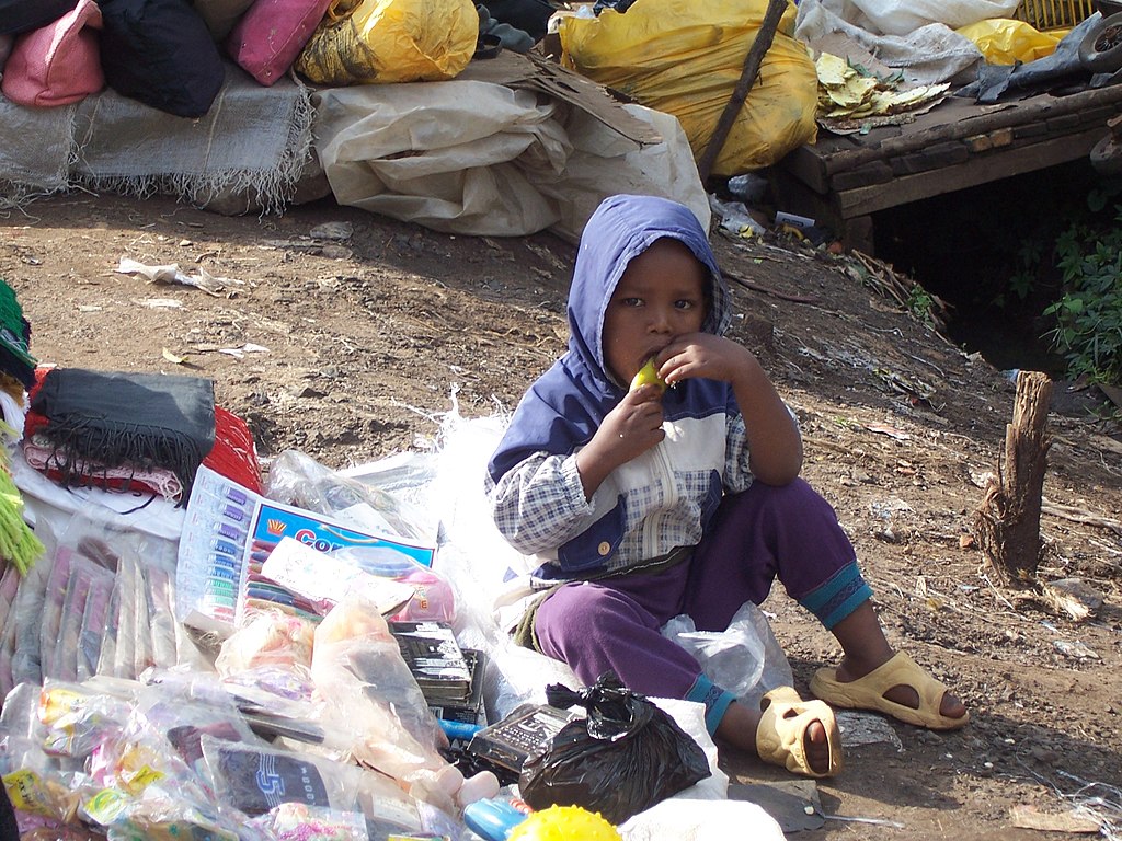 Street child eating pear