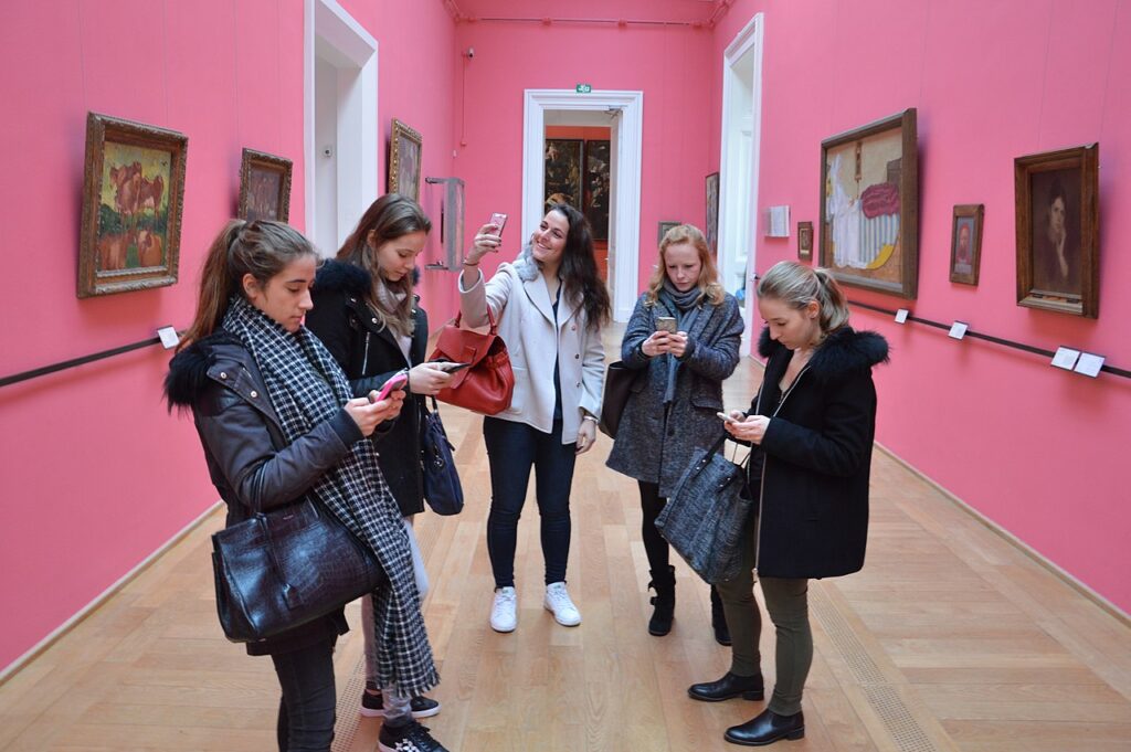 Generation-Z girls taking and sending photos while at the Lille Palace of Fine Arts Museum