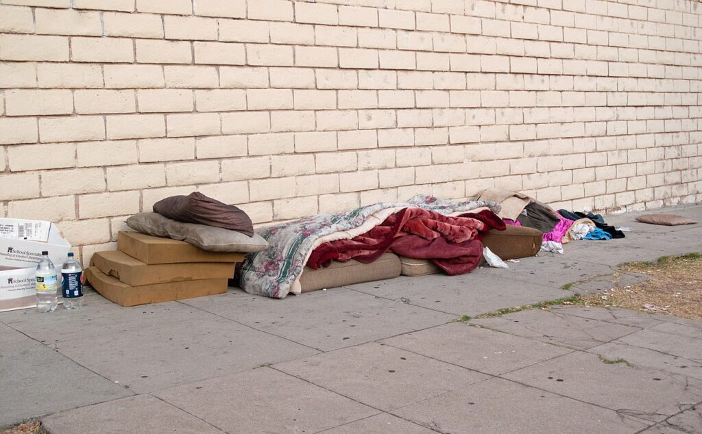 Bed, bedclothes and clothing of a homeless person who sleeps on the street. Los Angeles