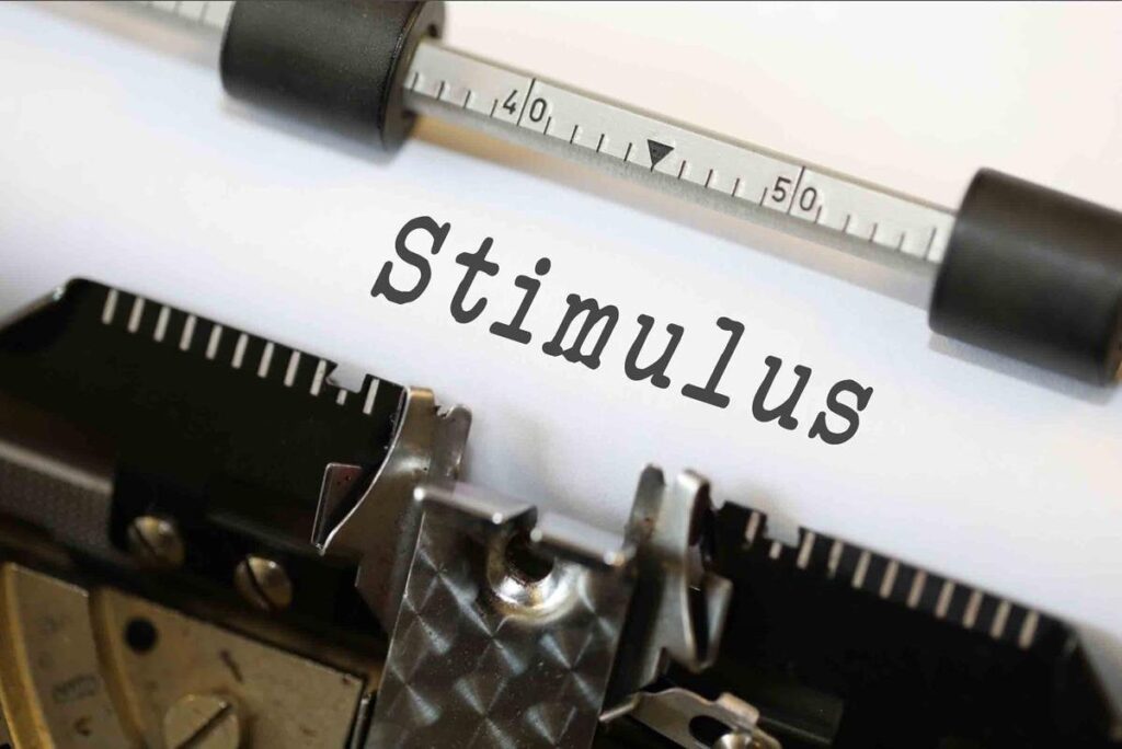 A typewriter with ‘stimulus’ written on its paper