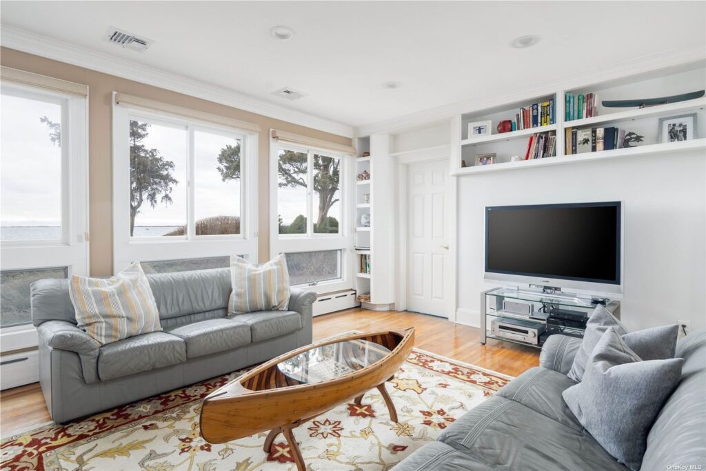 A living room with a model canoe as centerpiece