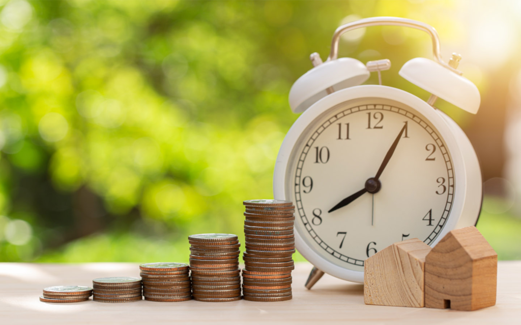 Tabletop timepiece and piles of coins