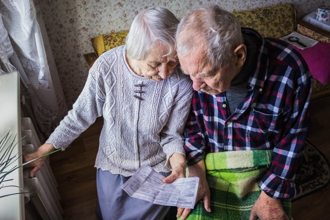 A senior couple sitting side-by-side