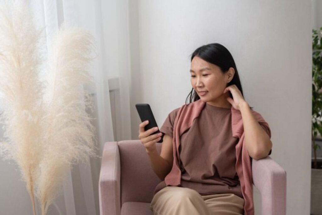 A woman staring at her smartphone