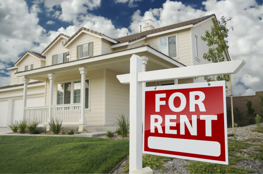 A family house with a “for rent” sign out front