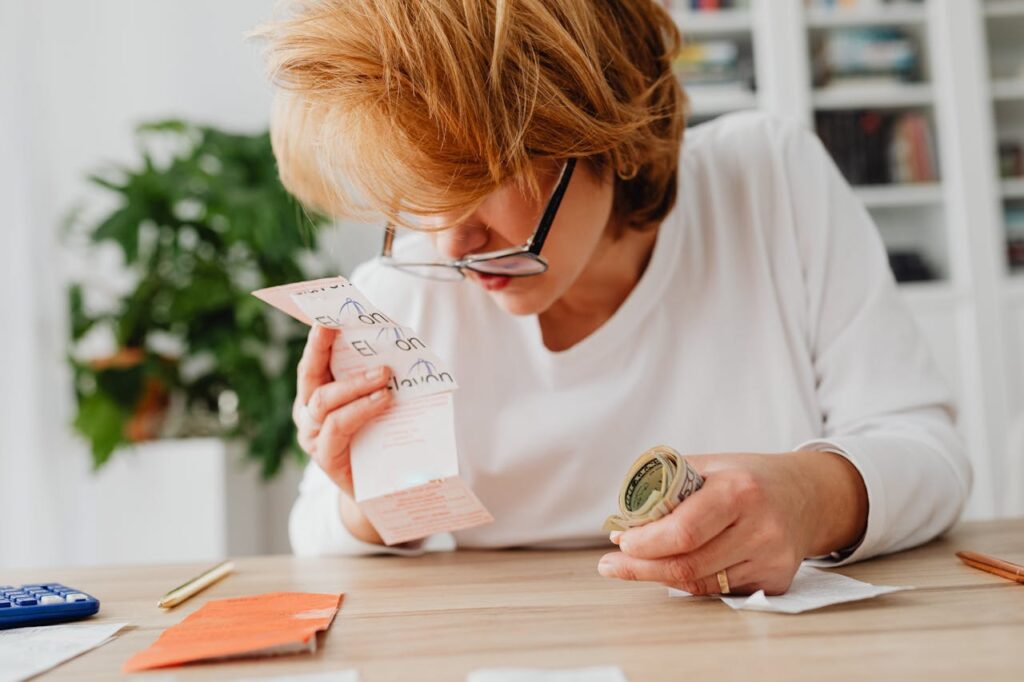 A woman bewildered going through her bills