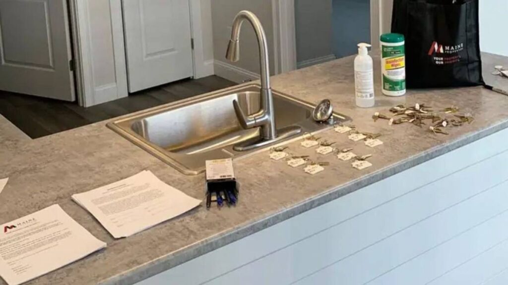 Labelled keys laid out next to a kitchen sink