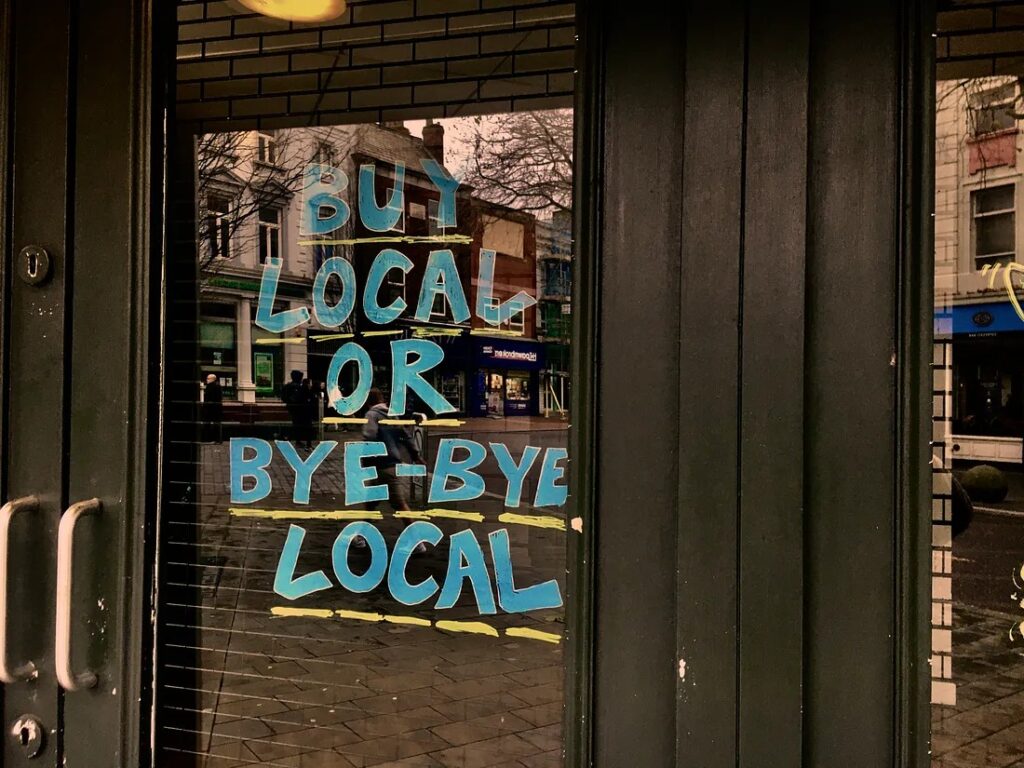 Text on the glass door of a local shop