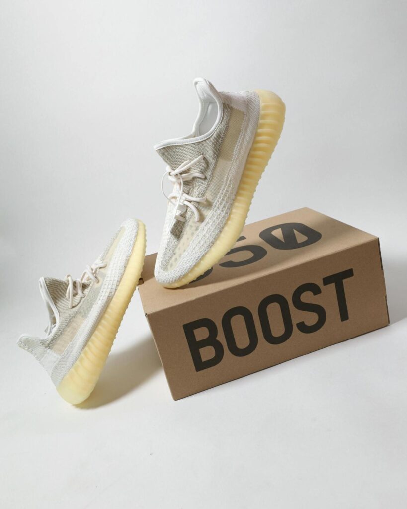 Pair of white sneakers in carton box