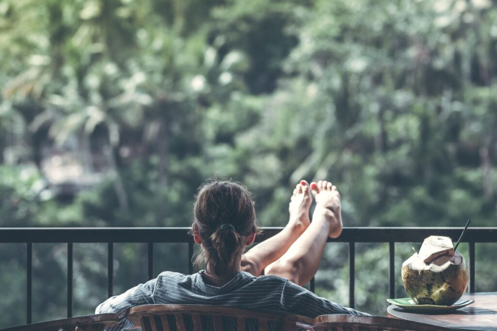 A young tourist reclining in a chair and taking in nature