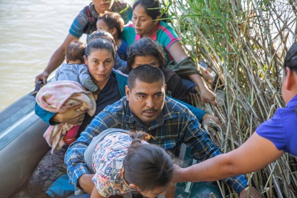 Migrants trying to get off a boat