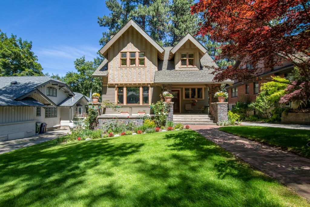 Brown and white house with a lovely lawn