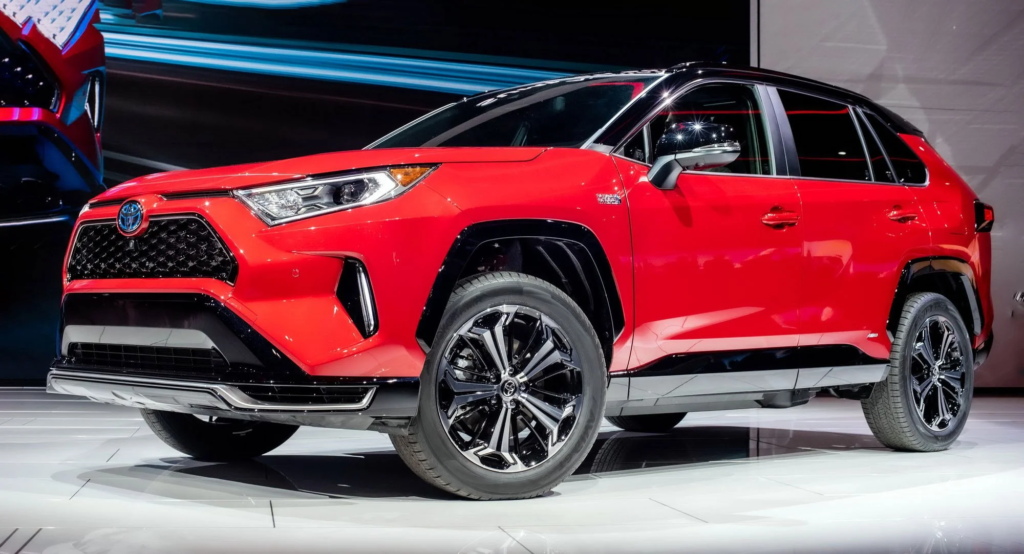 A red RAV4 PHEV in a showroom