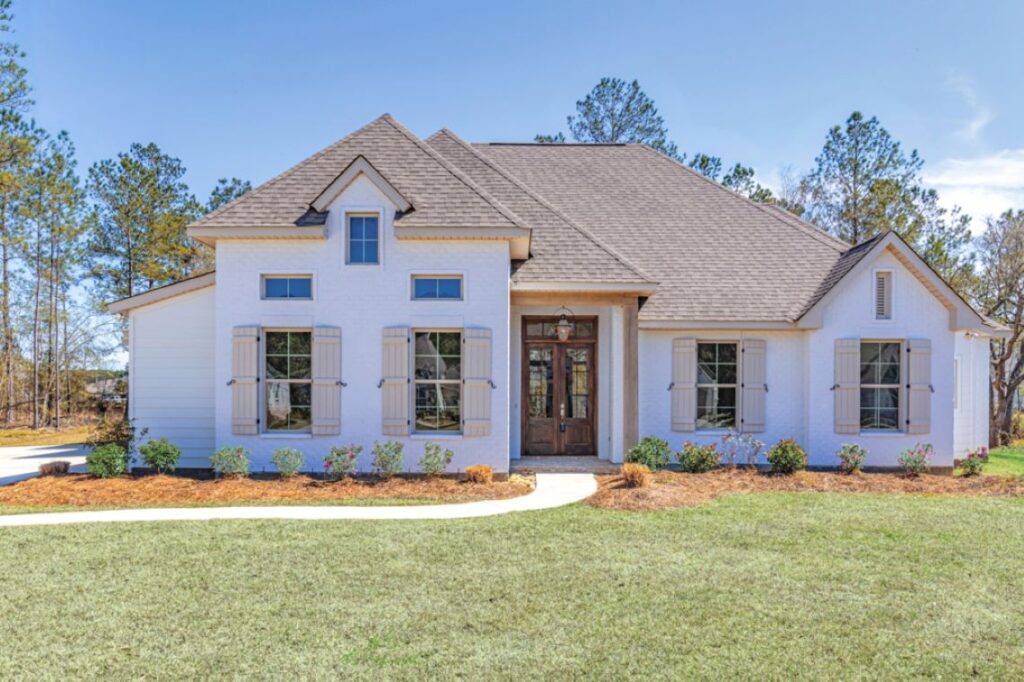 A white and lush single-family suburban house