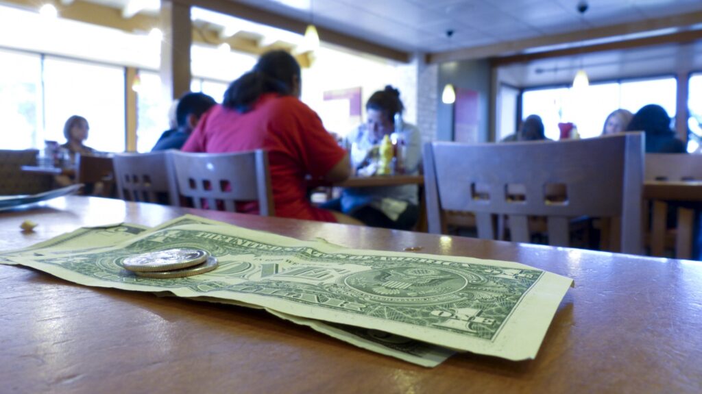 A diner leaves a tip after their meal