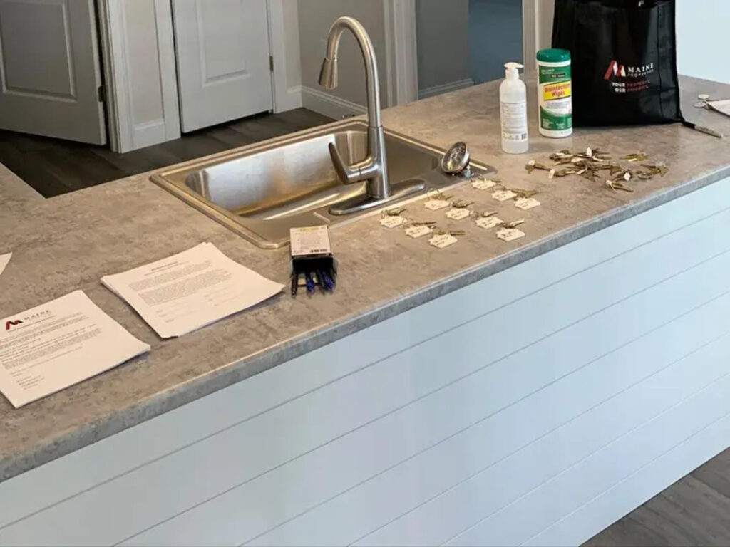 Labelled keys laid out next to a kitchen sink