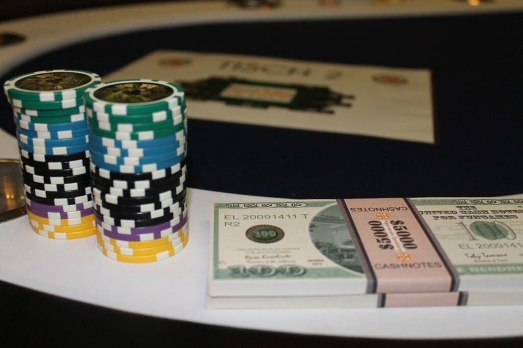 Stacks of money sitting on top of a table in a poker casino card game