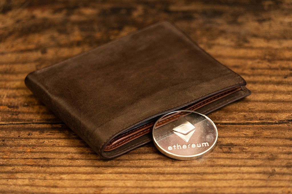 Ethereum medallion coin leaning on a wallet