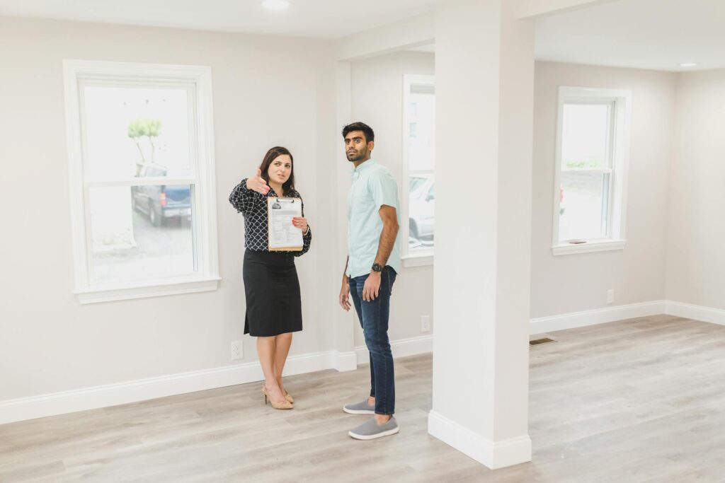 Woman Showing the Inside of House to a Man