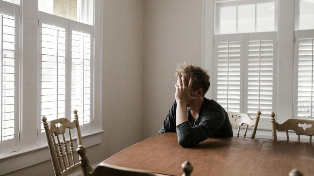 Photo of man leaning on table