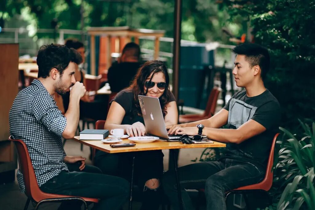 Three millennial friends working from a café