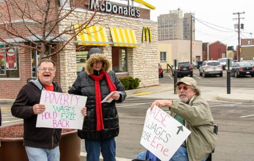 A couple of boomers protesting outside a McDonald's