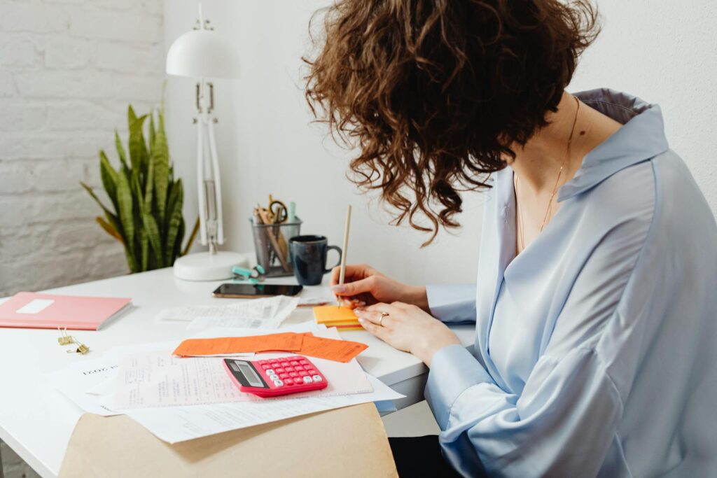 A woman writing on sticky notes