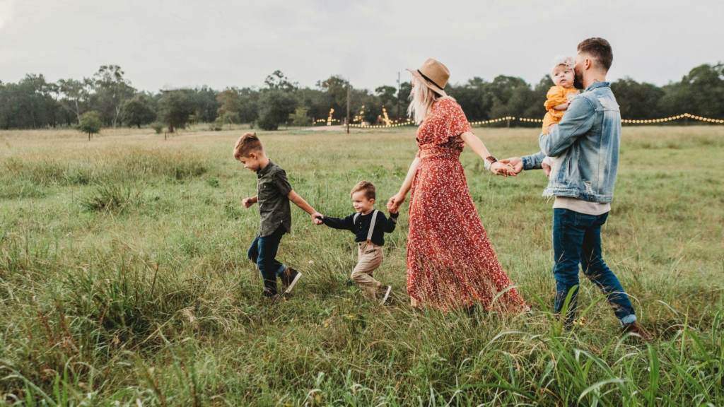 A family of five going for a walk in the countryside