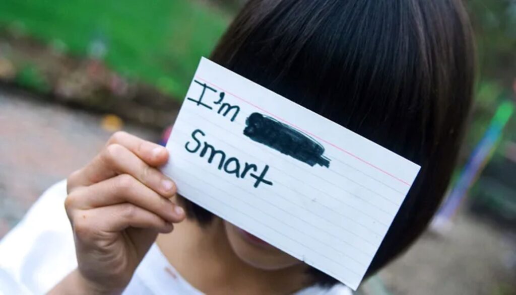 A youth holding up a note