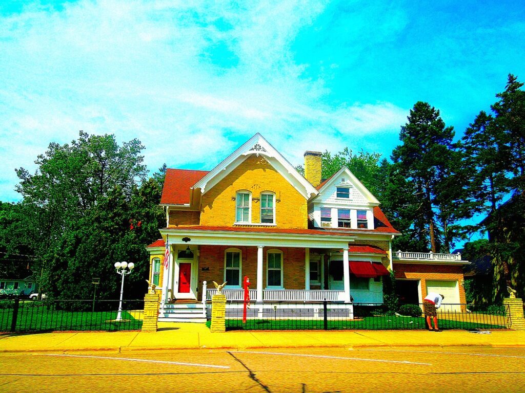 A colorful family house with a nice lawn and porch