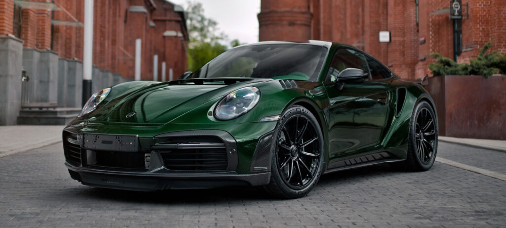 Green Porsche car parked in the middle of the street