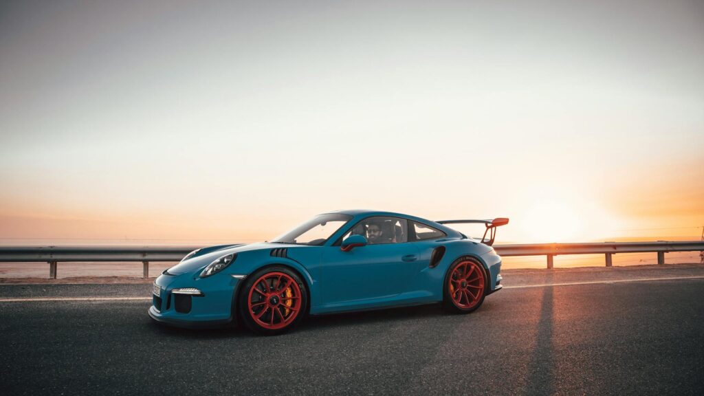 Blue Porsche 911 on Gray Asphalt Road