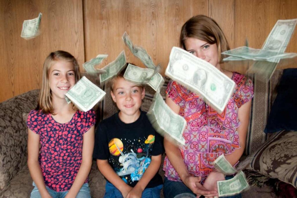 Dollar bills raining before three kids