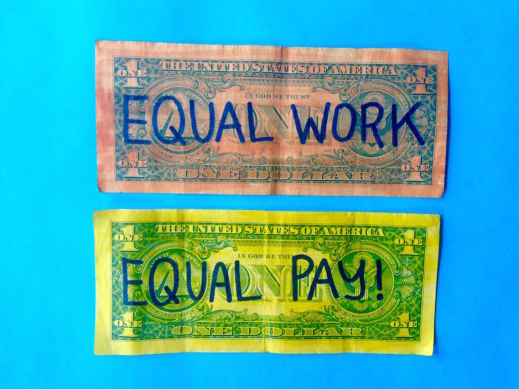 Altered dollar bills in protest for Equal Pay Day 2016. 
