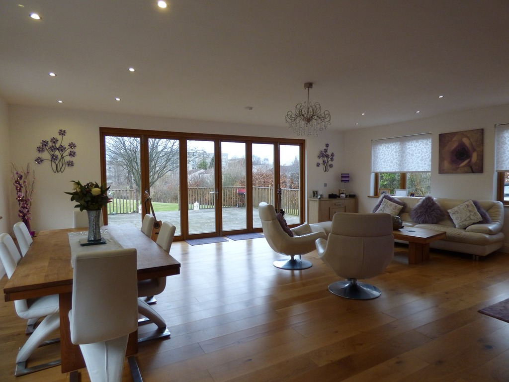 A living room filled with furniture and a wooden table