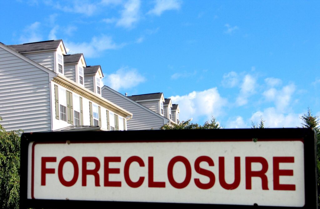 Apartment building with foreclosure sign out front