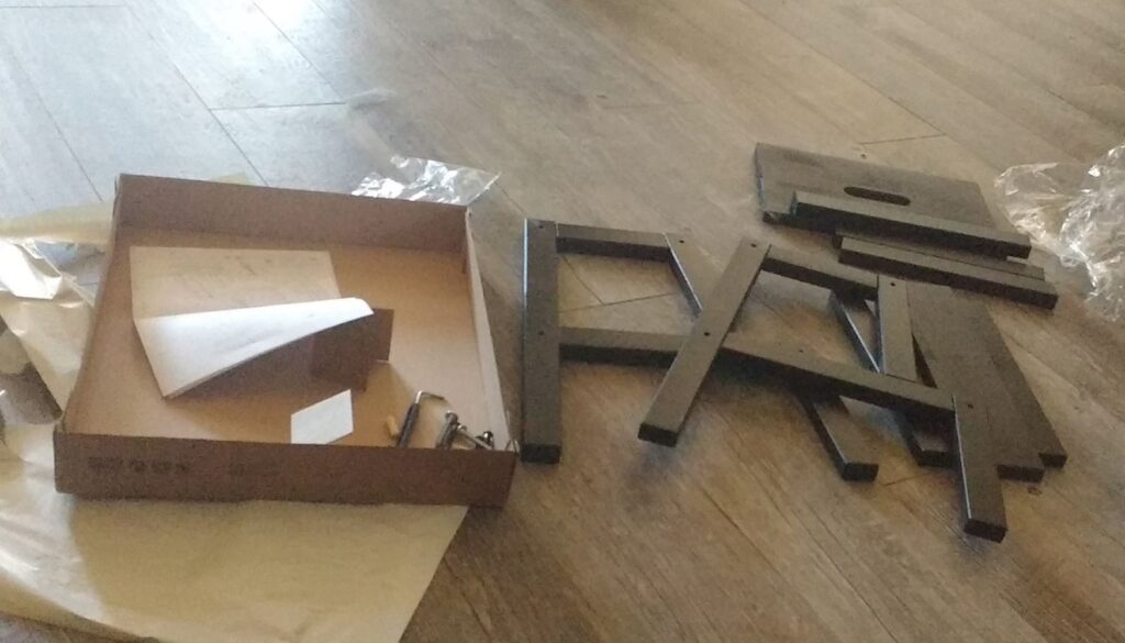 An unassembled IKEA flat-pack stool