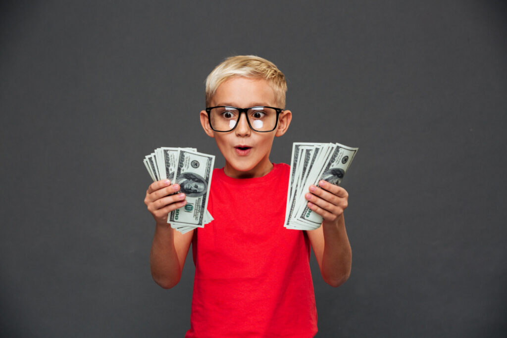 Young boy with a wad of cash