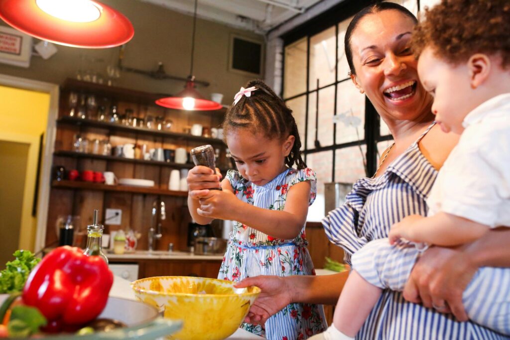 A little girl preparing food with her mother