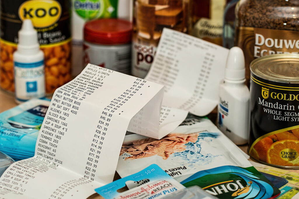 A long receipt next to groceries