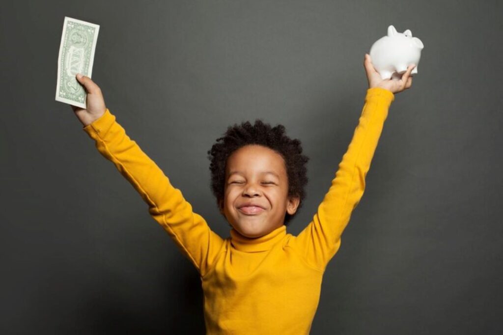 Boy with a dollar bill and piggybank